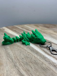 a pair of scissors are sitting on top of a wooden table next to some green plants