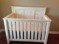 a white wooden crib in a room