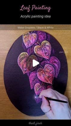 a person is drawing on a black and purple plate