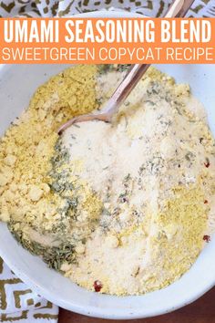 a white bowl filled with green food next to a wooden spoon