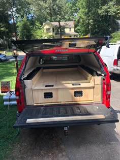 the back end of a red truck with its trunk open