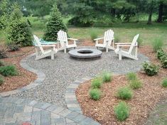 a fire pit surrounded by lawn chairs and trees