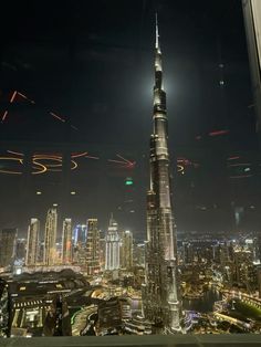 a night view of the city lights and skyscrapers from a high rise building window