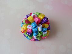 a colorful hair bow with polka dots and bows on it's center is the words easter loopy bow