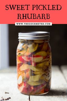 a jar filled with pickled rhubars on top of a wooden table