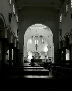 the inside of a church with pews and lights in black and white photo,