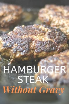 hamburger steak with gravy cooking in a skillet