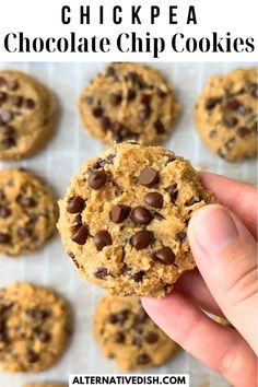 a hand holding up a chocolate chip cookie