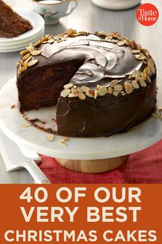 a cake with chocolate frosting and nuts on top is sitting on a white plate