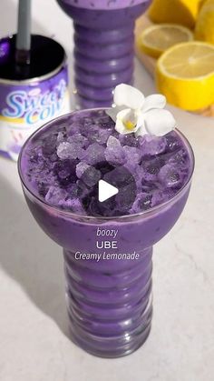 a purple drink with ice and flowers in it