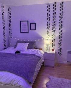 a bed room with a neatly made bed and pictures on the wall