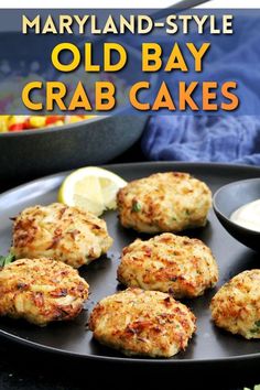 old bay crab cakes on a plate with lemon wedges and garnishes