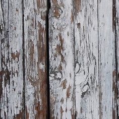 an old wooden fence with peeling paint on it