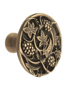 an antique style door knob with grapes and leaves on it