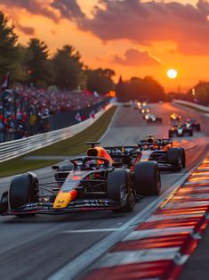 the race cars are racing down the track at sunset