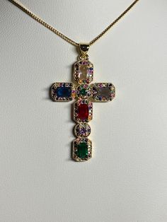 Golden cubic Zirconia cross pendant, necklace Pendant has inlaid colored zirconia stones pendant width 1 inches/2.5 cm pendant height 1 5/8 inches/4.2 cm chain length 17.5-19.5 inches / 44.5-49.5 cm comes with a golden chain as well as a gift bag beautiful colored design gives them such a unique look perfect for First Communion, Baptism, Religious celebrations, birthdays, Easter, Mother's day The colors from your monitor might vary slightly from actual colors Please have a look at the other item Cross Jewelry Jewelry1000.com, Necklaces Of The Cross, Gemstone Cross Jewelry, Cross Green Necklace, Hand Made Cross Necklace, Avon Cross Necklace, Gem Cross Necklace, Statement Cross Necklace, Unique Cross Necklace