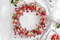 a plate with strawberries and other food on it