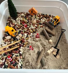 a white container filled with sand and toys