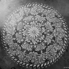 an intricate design on the floor in black and white