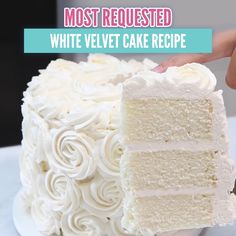 someone is holding a piece of white cake