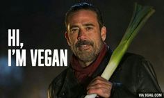 a man holding a large stalk of celery in his hand with the words hi, i'm vegan on it