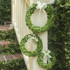 two wreaths hanging from the side of a building