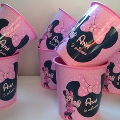 there are many cups with minnie mouse designs on them, all in pink and black