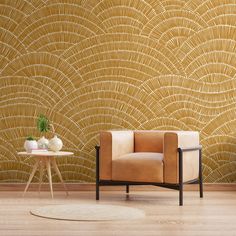 a chair and table in front of a gold wallpaper