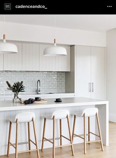 three stools are in front of the kitchen island