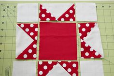 red and white quilted block with polka dots on it