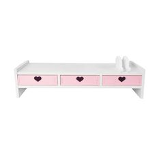 a white bench with pink drawers and hearts on it