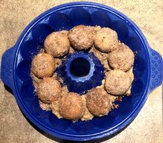 a blue bowl filled with food on top of a counter