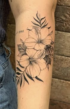 a black and white flower tattoo on the arm