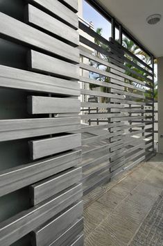 an outdoor area with metal slats on the walls and floor, along with a large window