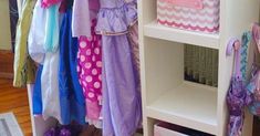 a white shelf filled with lots of colorful clothes