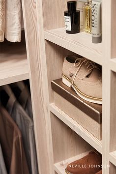 a pair of shoes sitting on top of a wooden shelf next to a shoe rack