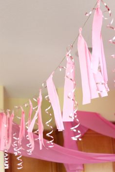 pink streamers and streamers hanging from the ceiling