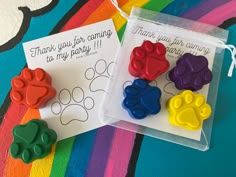 three plastic paw prints are shown in front of a thank you for company card