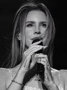 a woman holding a microphone up to her mouth