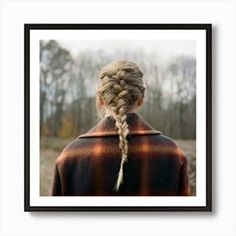 a woman with braids in her hair looking out into the distance, framed photograph