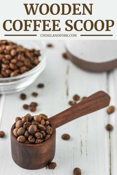 a wooden spoon filled with coffee beans on top of a white table next to a bowl of coffee beans