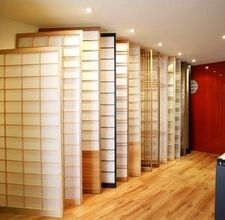 there are many bookshelves in the room with wood flooring and white walls