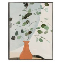 an orange vase filled with green leaves on top of a table