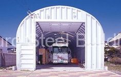 a bus is coming out of a white building with red and blue checkered flooring