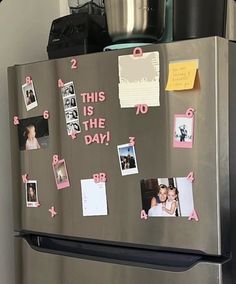 a refrigerator covered in magnets and pictures with pink stickers on the front door