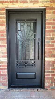 the front door to a brick building with an iron grill design on it's side