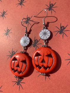 These Halloween earrings have a big orange pumpkin dangling from a creepy spiderweb charm! Spooky Nickel-free Earrings For Halloween, Dangle Halloween Earrings, Spooky Halloween Drop Earrings, Spooky Pierced Earrings For Halloween, Halloween Orange Nickel-free Earrings, Spooky Red Halloween Jewelry, Nickel Free Orange Halloween Earrings, Nickel-free Orange Earrings For Halloween, Orange Nickel-free Earrings For Halloween