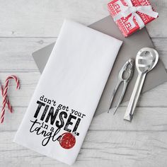 a napkin that says don't get your tinsel in a tangle next to some candy canes