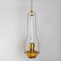 an old fashioned light hanging from a ceiling