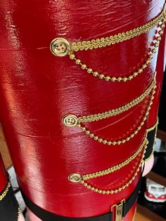 an image of the back of a red costume with chains on it's waist